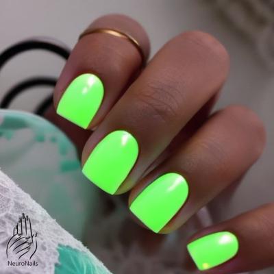 The bright green light of neon nails